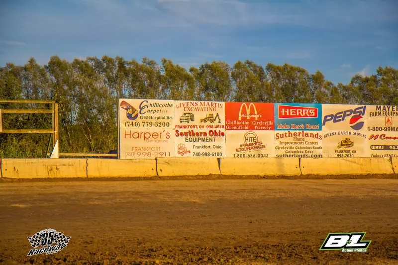 Row of sponsor billboards along the backstretch in daylight